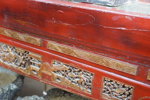 A Chinese carved scarlet and gilt painted altar table with faux stone top, length 198cm, depth 41cm, height 98cm